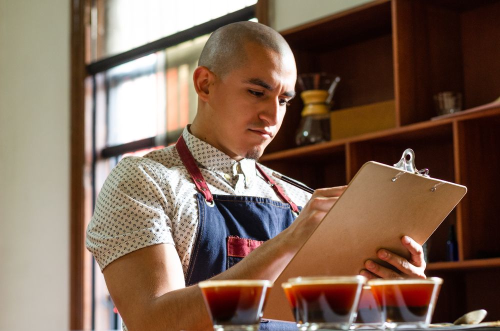 A man examining coffee