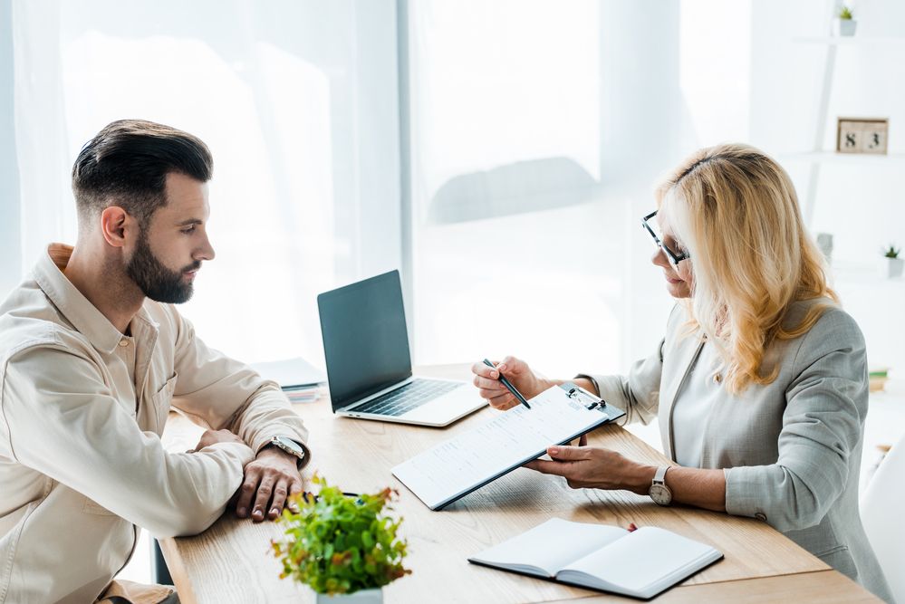 A man and woman talking inside an office