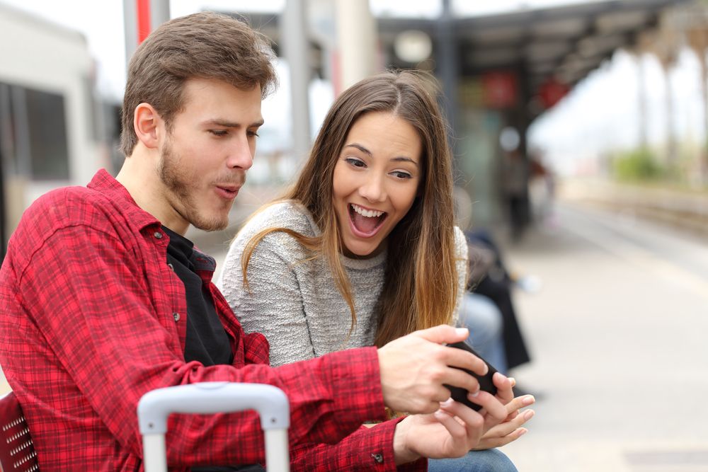 A man and woman looking at a phone