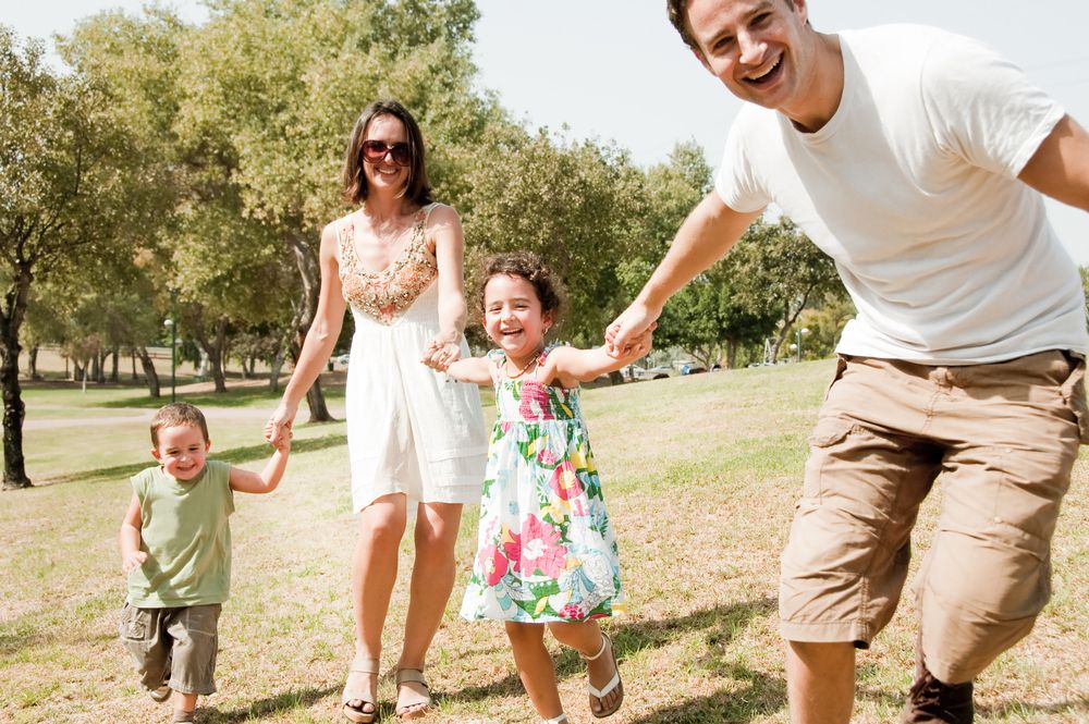 A man, woman, boy, and girl in a park