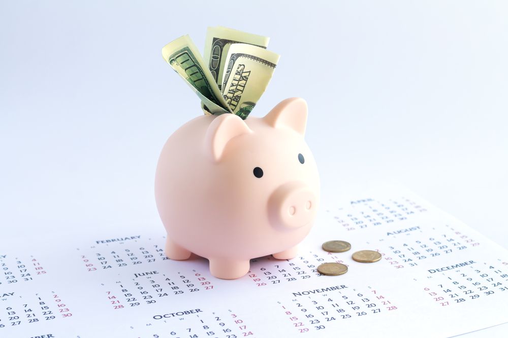 A piggy bank on a calendar