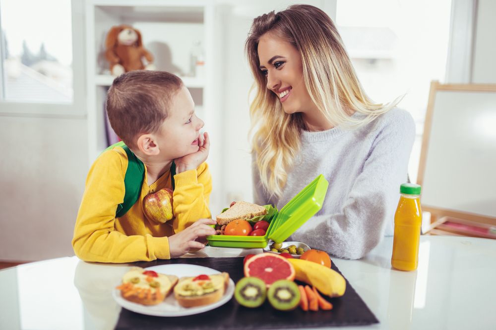 A woman and a boy bonding over snacks