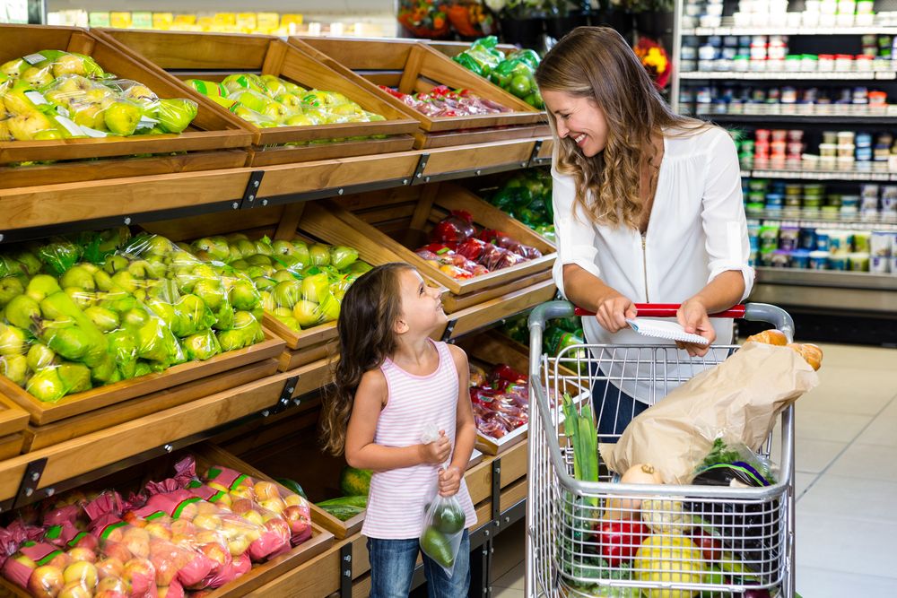 A woman and a girl doing grocery shopping