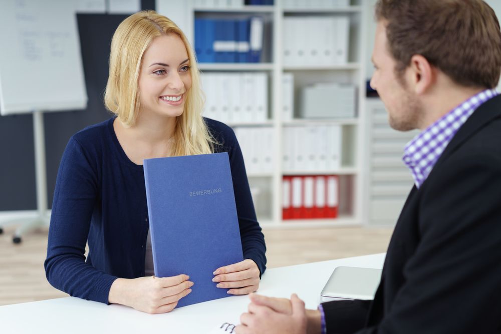 A woman being interviewed by a man
