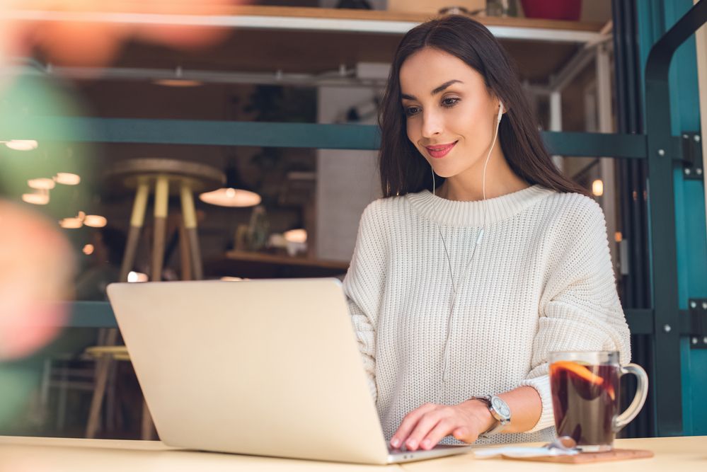 A woman using a laptop at a restaurant