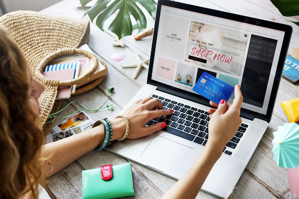 A woman with her laptop and credit card