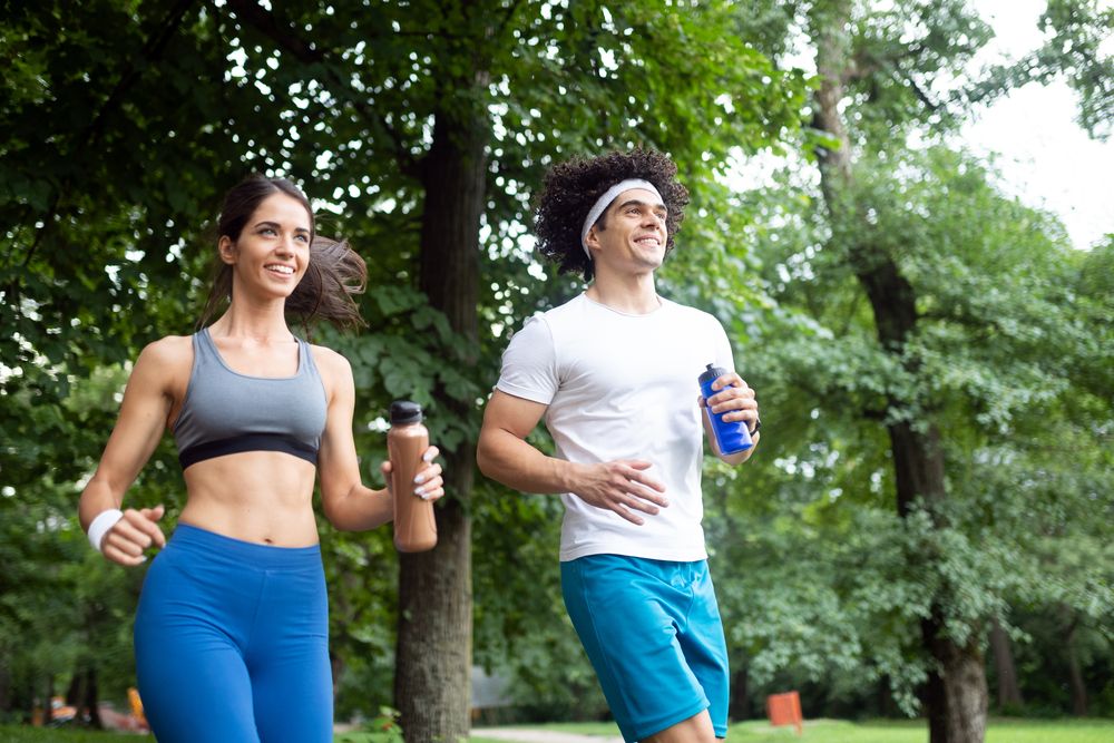 A young man and young woman jogging together