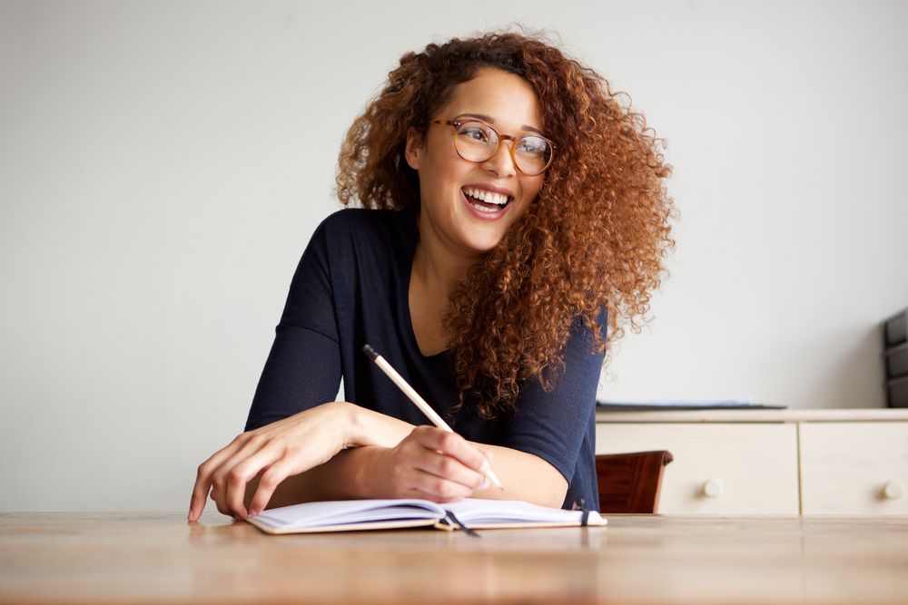A young woman with a pencil and a notebook